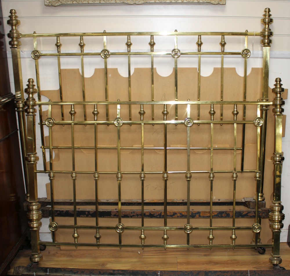 An Edwardian brass double bedstead, with ring turned finials and squared bars, W.156cm H. headboard 159cm footboard 121cm L.190cm appro